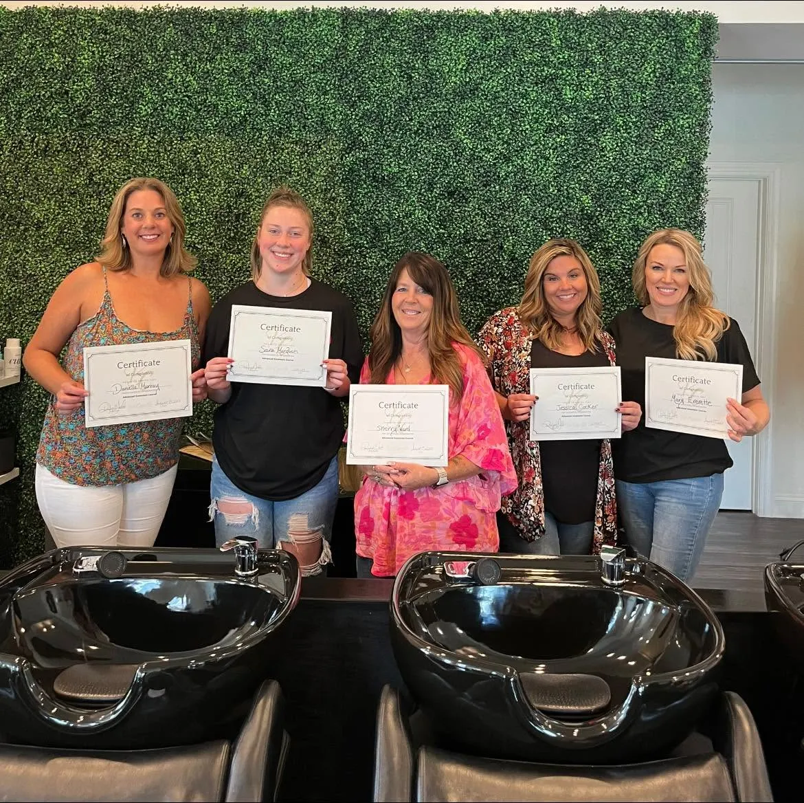 Miracles Salon & Spa stylists with certificates after an advanced education class