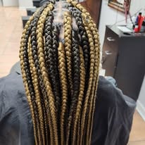Knotless box braids with blonde ends at Miracles Salon & Spa in Shallotte, NC