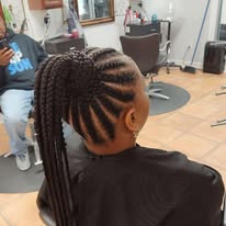Feed-in cornrows into a sleek braided ponytail at Miracles Salon & Spa in Shallotte, NC