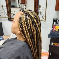 Long box braids with a blonde ombre at Miracles Salon & Spa in Shallotte, NC
