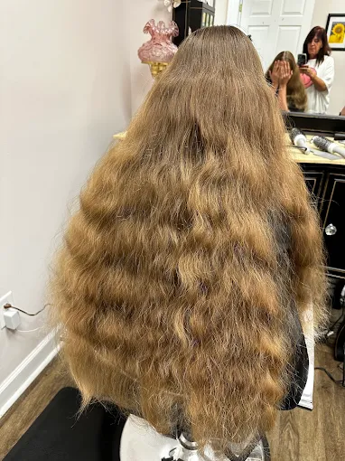 Long, thick natural waves at Miracles Salon & Spa in Shallotte, NC