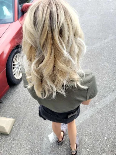 Blonde balayage with loose curls at Miracles Salon & Spa in Shallotte, NC