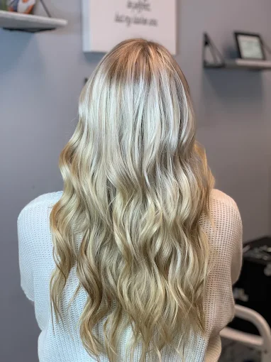 Long blonde balayage with beachy waves at Miracles Salon & Spa in Shallotte, NC