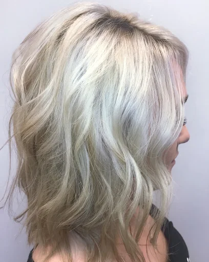 Icy blonde lob with soft waves at Miracles Salon & Spa in Shallotte, NC