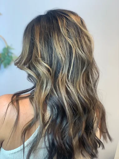 Dimensional brunette-to-blonde color, side view, at Miracles Salon & Spa in Shallotte, NC