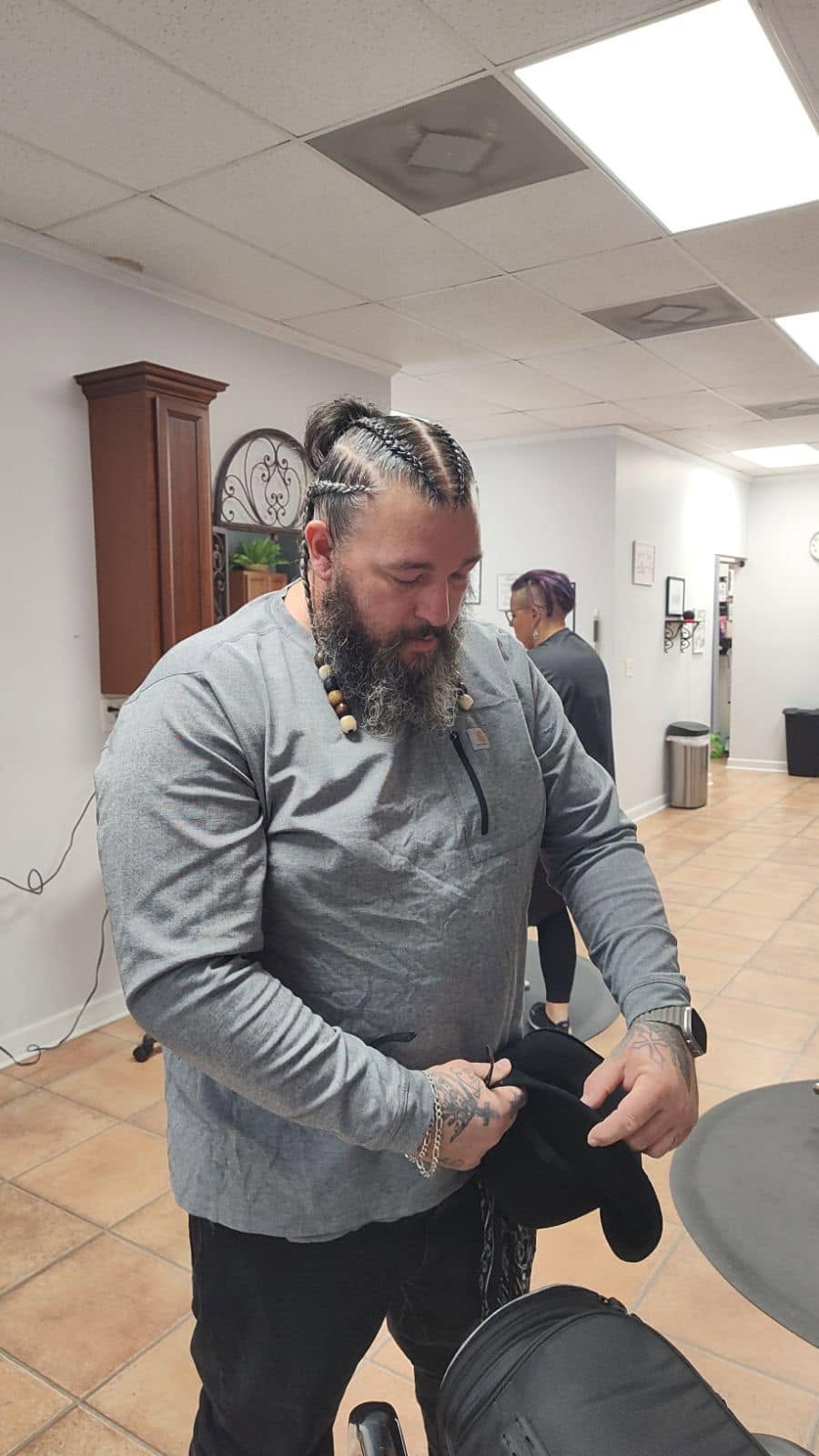 Men's cornrow braids finished in a bun at Miracles Salon & Spa in Shallotte, NC
