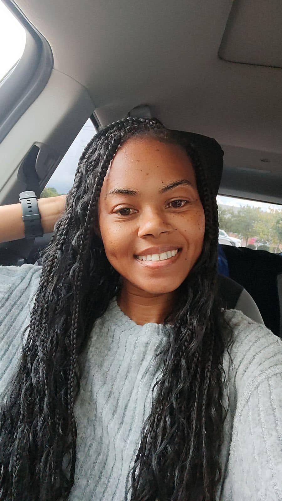 Long box braids with a curly, bohemian finish at Miracles Salon & Spa in Shallotte, NC