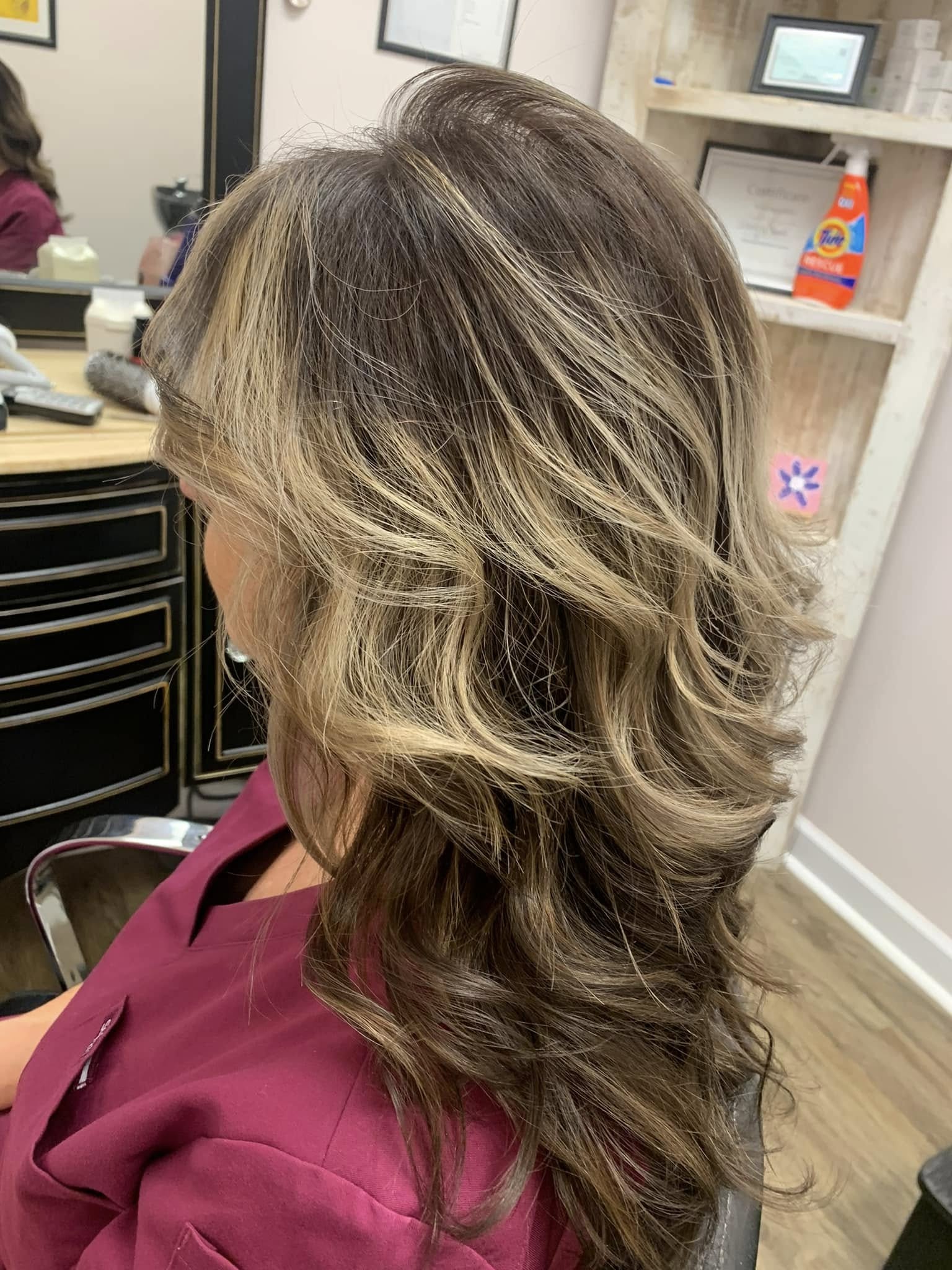 Bright, dimensional highlights finished with a soft blowout at Miracles Salon & Spa in Shallotte, NC