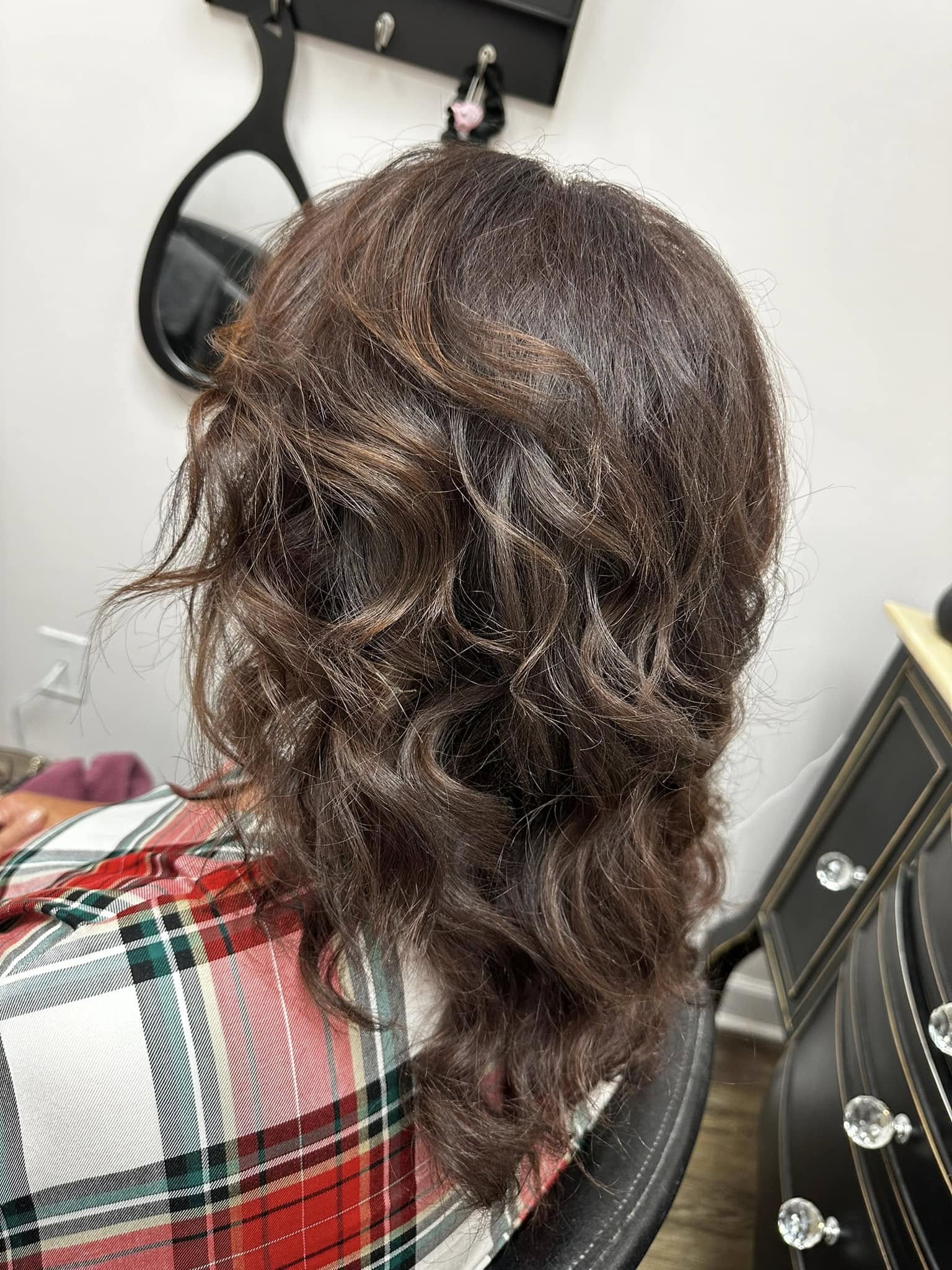 Brunette waves with a soft curl at Miracles Salon & Spa in Shallotte, NC