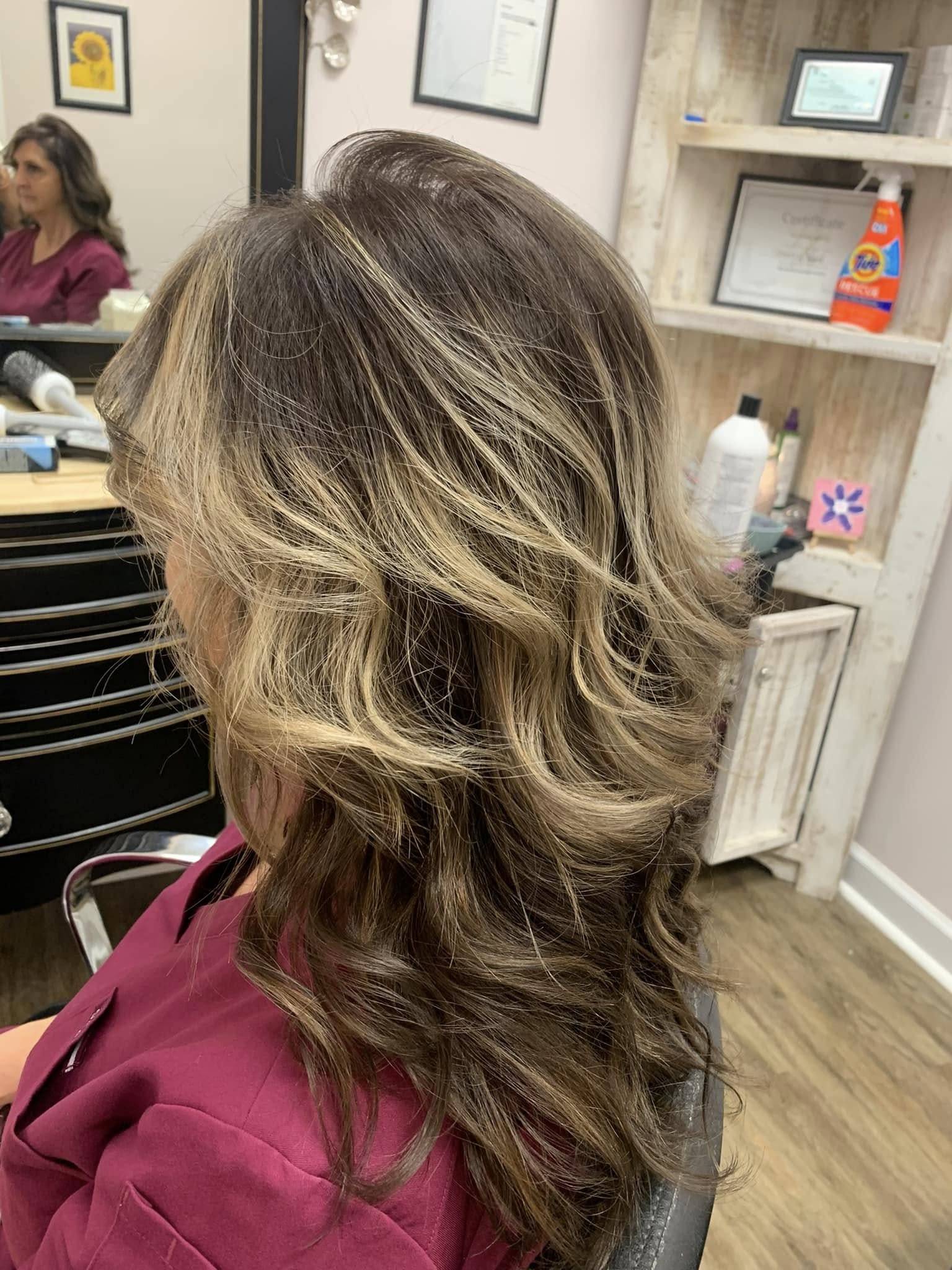 Blonde highlights blended through the mid-lengths at Miracles Salon & Spa in Shallotte, NC