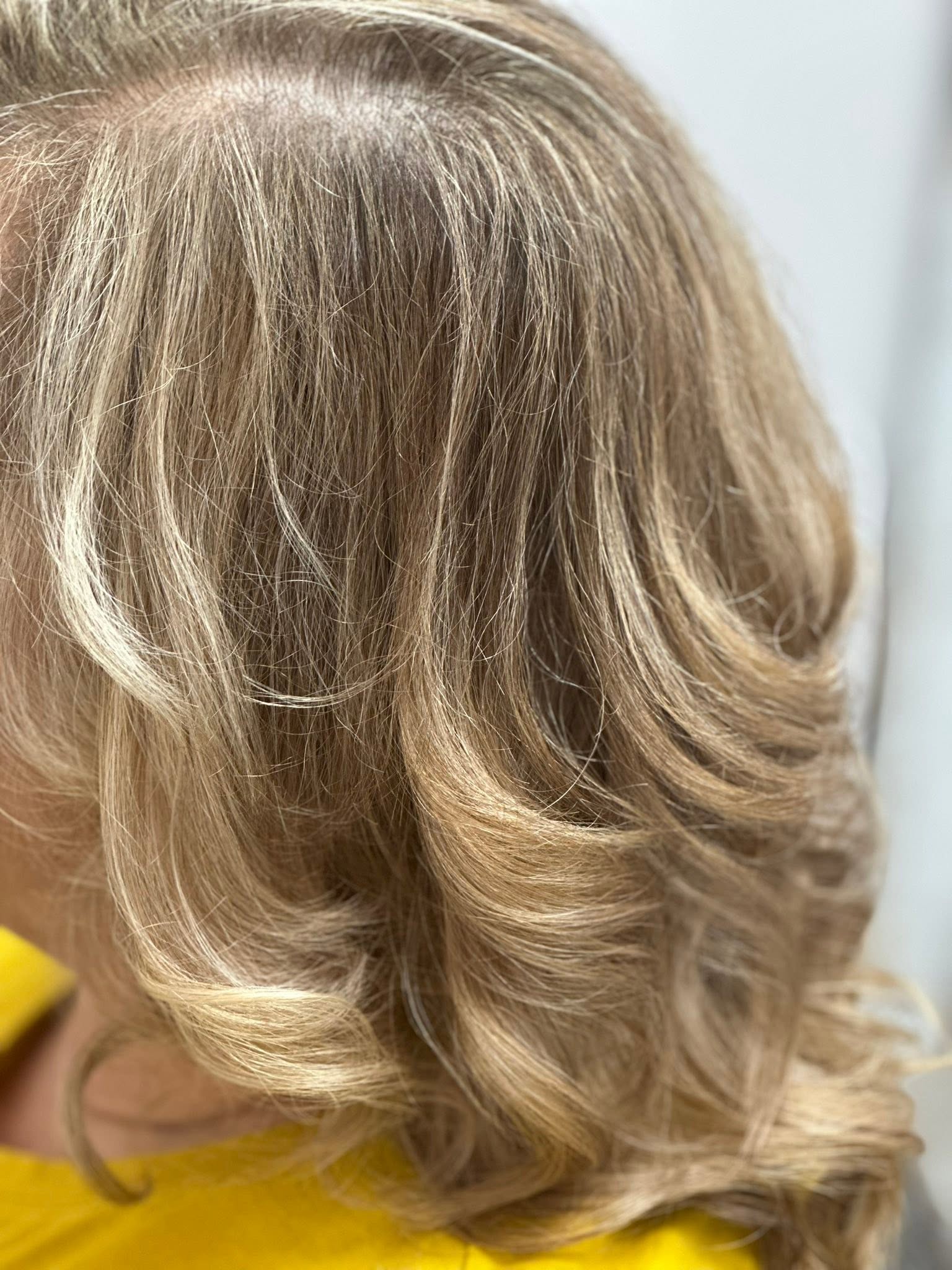 Soft blonde highlights and a shine-boosting gloss at Miracles Salon & Spa in Shallotte, NC