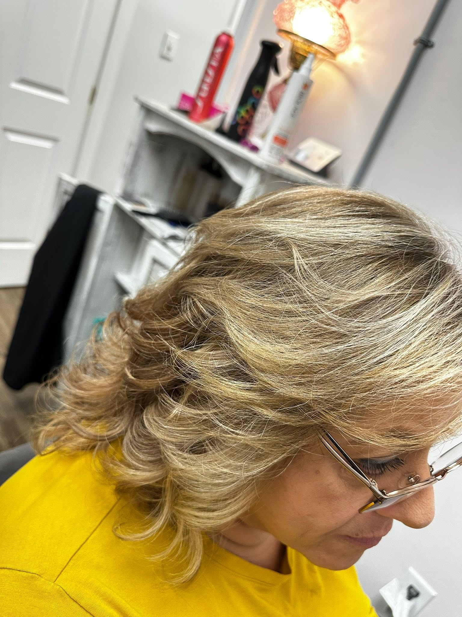 Refined blonde blowout with dimension at Miracles Salon & Spa in Shallotte, NC