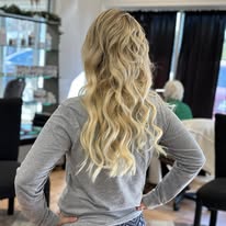 Soft blonde waves, back view, at Miracles Salon & Spa in Shallotte, NC