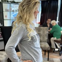 Long blonde curls, side profile, at Miracles Salon & Spa in Shallotte, NC