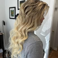 Blonde balayage with a lived-in root, side view, at Miracles Salon & Spa in Shallotte, NC